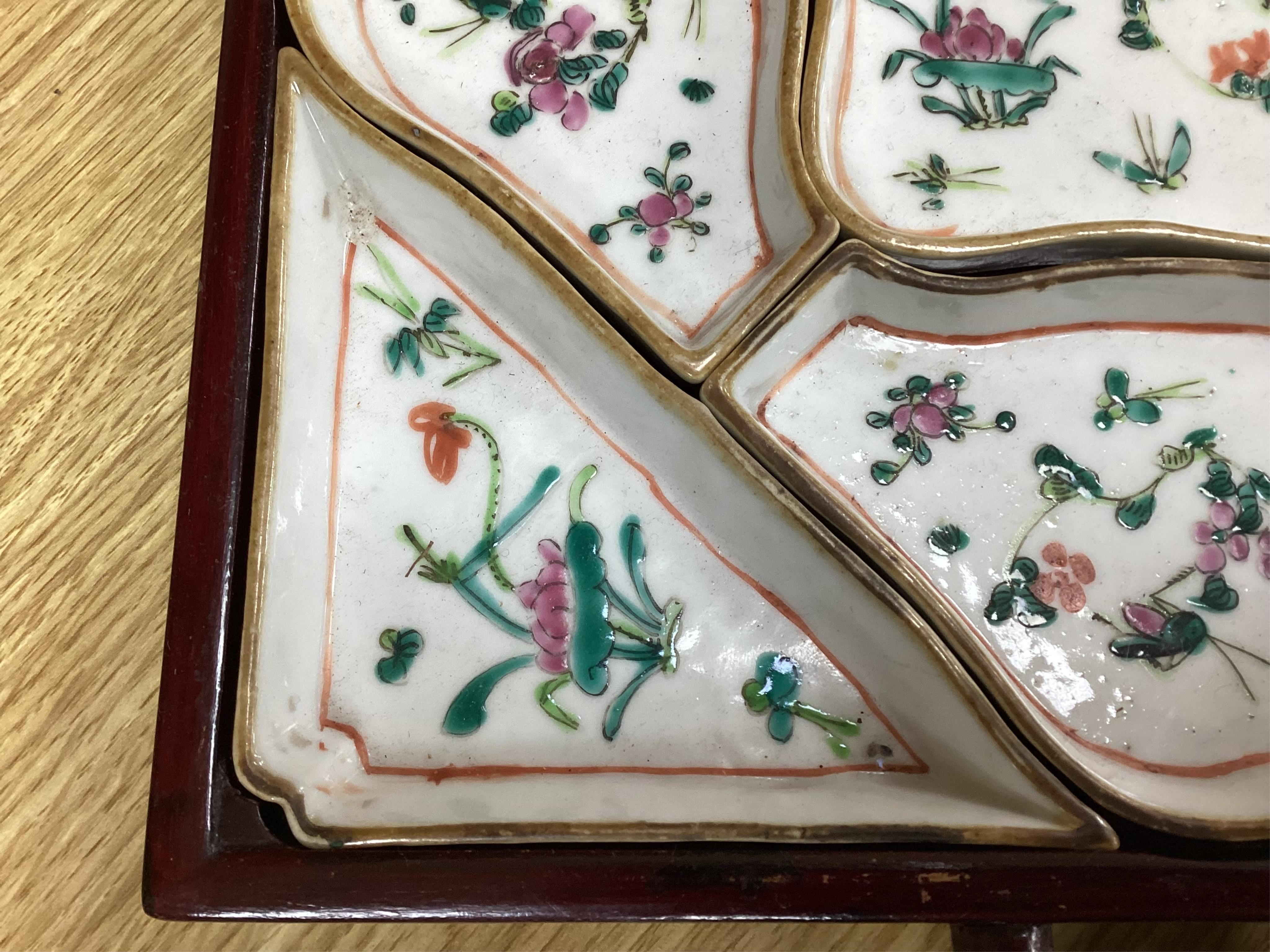 A square Chinese hardwood tray of famille rose geometric dishes, 30cm. Condition - fair to good